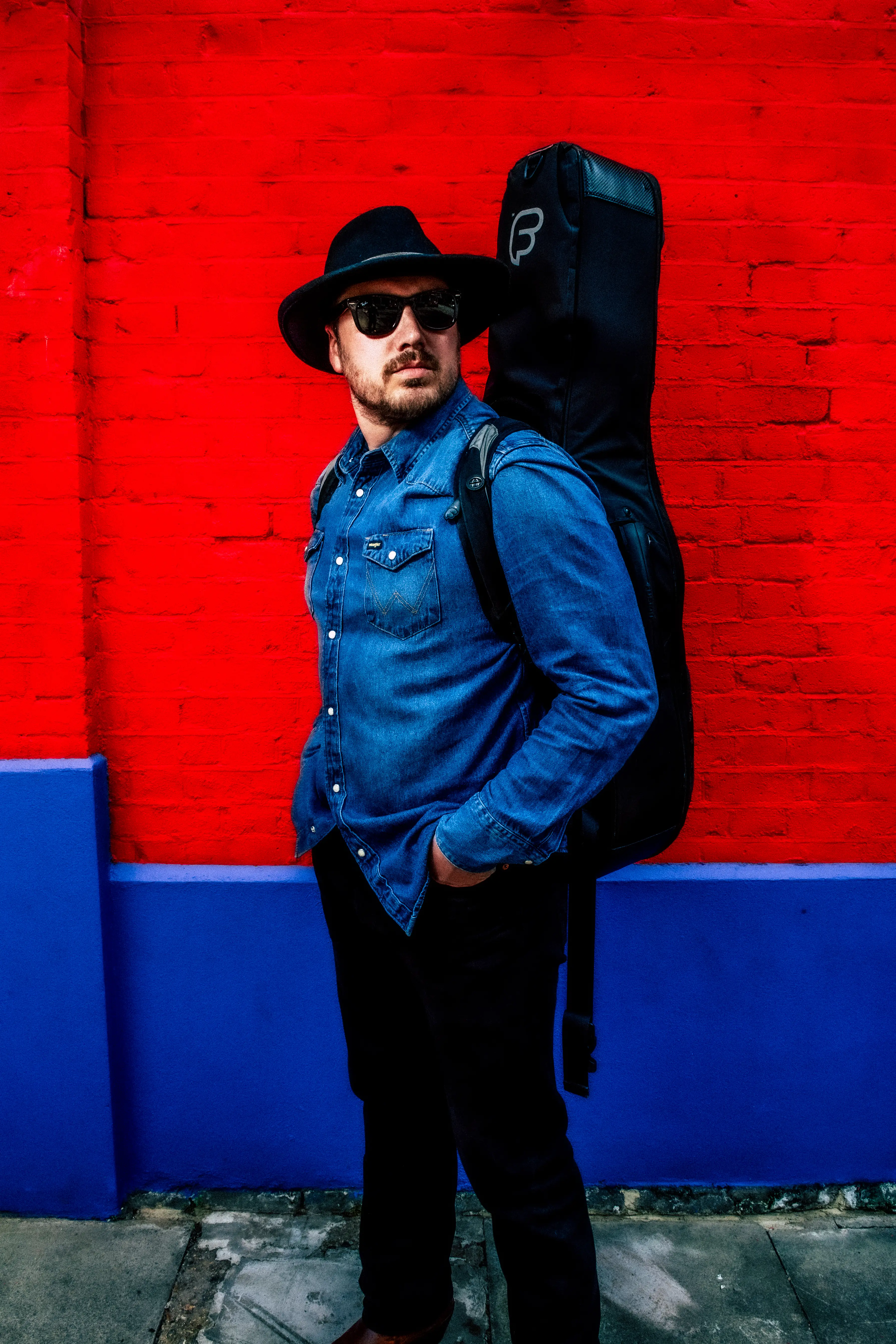 Ben Joseph standing in front of a red wall